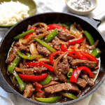 Sizzling one pan pepper steak with colorful bell peppers and onions in a savory sauce.