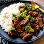 One Pan Chinese Beef and Broccoli with tender flank steak and bright green broccoli served over white rice.
