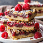 Chocolate Raspberry Bars freshly baked in an 8×8-inch pan, showing a gooey raspberry layer and melted chocolate chips.