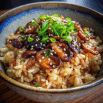 One Pot Soy Sauce Mushroom Rice served in a bowl with scallion garnish