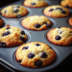 Freshly baked Blueberry Muffins in One Bowl arranged on a wire rack