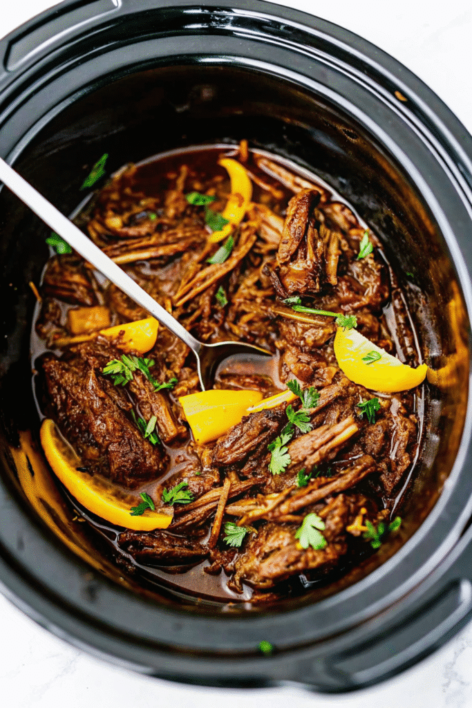 Juicy Crock Pot Mississippi Pot Roast ready to serve with savory au jus sauce and melted butter
