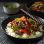 Crock Pot Pepper Steak with tender sirloin strips, colorful bell peppers, and onions in a savory sauce, served over white rice.