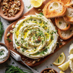 Butter Board Recipe with creamy European-style butter, fresh herbs, citrus zest, and toasted nuts arranged on a wooden board.
