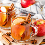 Slow Cooker Spiced Apple Cider in a rustic mug with orange slices and cinnamon sticks
