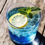 Refreshing Blue Salt Trick drink in a glass with mint garnish