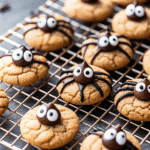 A tray of Spider Cookies with chocolate ganache spiders and candy eyes, ready to serve.