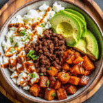 Ground Beef Hot Honey Bowl with roasted sweet potatoes, creamy avocado, and cottage cheese drizzled with hot honey