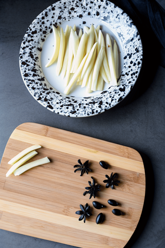 Key ingredients for Spiderweb Pizza including string cheese, black olives, pizza dough, and marinara sauce