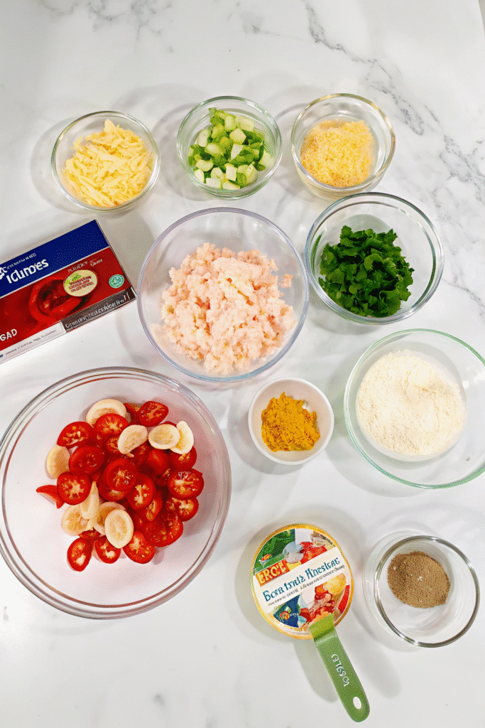 Fresh ingredients for Easy Lobster Bisque Pasta including fettuccine, langostino lobster, cherry tomatoes, garlic, onion, Parmesan, and lobster bisque