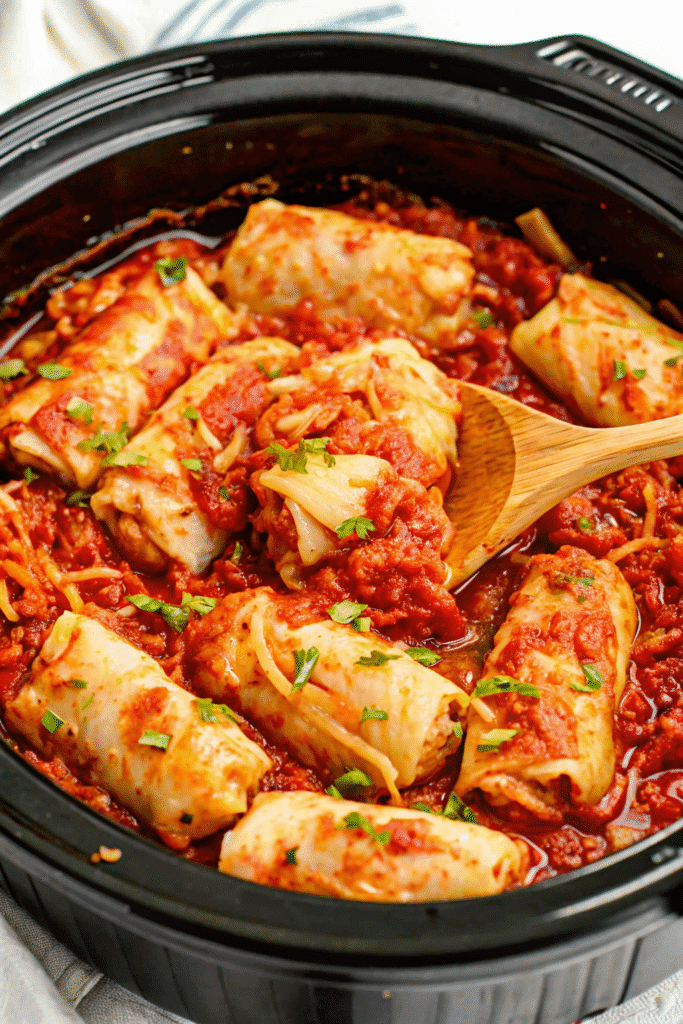 Close-up of Crock Pot Unstuffed Cabbage Rolls topped with melted cheese, ready to serve.