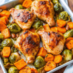 Sheet Pan Maple Dijon Chicken with Sweet Potatoes roasted with Brussels sprouts, shallots, and bacon, glazed with maple Dijon sauce.