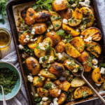Mediterranean Herb Chicken and Potato Sheet Pan with golden roasted chicken, baby potatoes, garlic, lemon slices, and fresh herbs.