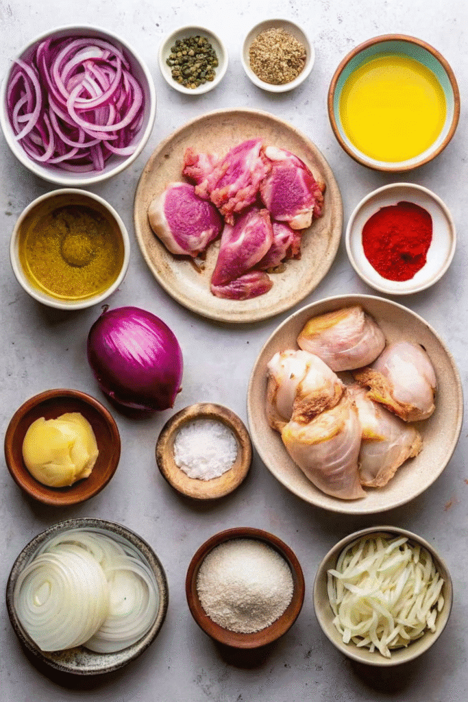 Ingredients for Chicken Shawarma Sheet Pan Dinner including chicken thighs, Greek yogurt, garlic, lemon, spices, and red onion.
