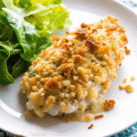 Golden baked Christmas Day Chicken with crispy buttered cracker coating served on a festive holiday platter.