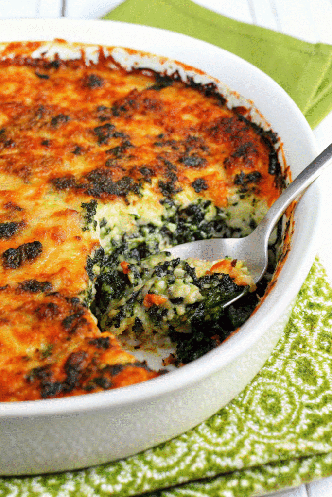 Slice of Ground Beef Spinach Casserole served on a plate showing layers of beef, spinach, and melted cheese.