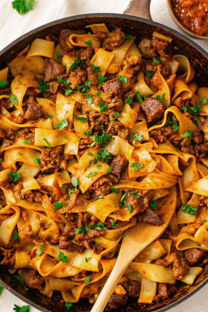 Close-up of a one-pan Cheesy Ground Beef and Cabbage Skillet with melted cheddar on top.