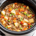 Crockpot Hamburger Soup with tender ground beef, colorful vegetables, and rich broth in a white bowl.