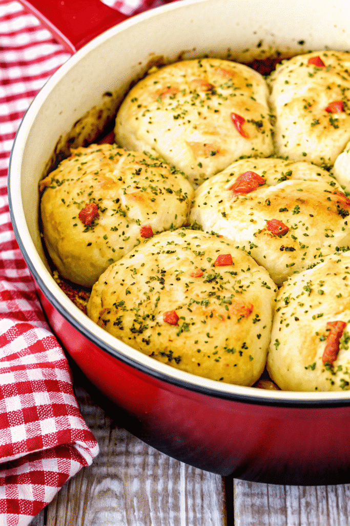 Freshly baked Thanksgiving Stuffing Rolls sliced to reveal a warm, herb-filled stuffing inside.
