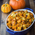 Golden-baked Thanksgiving Pumpkin Stuffing in a ceramic dish, garnished with fresh parsley