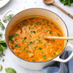 Slow Cooker Chicken Stew with tender chicken, carrots, potatoes, and herbs in a rich broth served in a bowl.