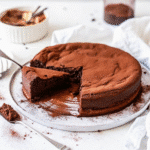 Slice of 6 Ingredient Flourless Chocolate Cake on a plate, showing its rich, fudgy texture.