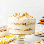 Homemade Magnolia Bakery Banana Pudding layered with Nilla wafers, fresh banana slices, and creamy vanilla pudding in a trifle dish.