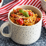 One Pan Spaghetti Skillet with ground beef, diced tomatoes, and melted mozzarella in a large skillet