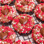 Close-up of freshly baked Chocolate Valentine Day Cookies with Sprinkles, showing melted chocolate chips and colorful festive sprinkles.
