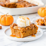Warm Pumpkin Dump Cake in a 6x6 baking dish topped with golden cake crust and chopped nuts