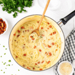 Bowl of Crack Chicken Noodle Soup with tender chicken, crispy bacon, creamy broth, and garnished with fresh parsley.