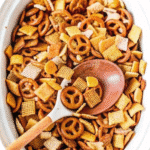 Slow Cooker Chex Mix with Rice, Corn, and Wheat Chex, pretzels, bagel chips, Bugles, and peanuts in a large slow cooker.