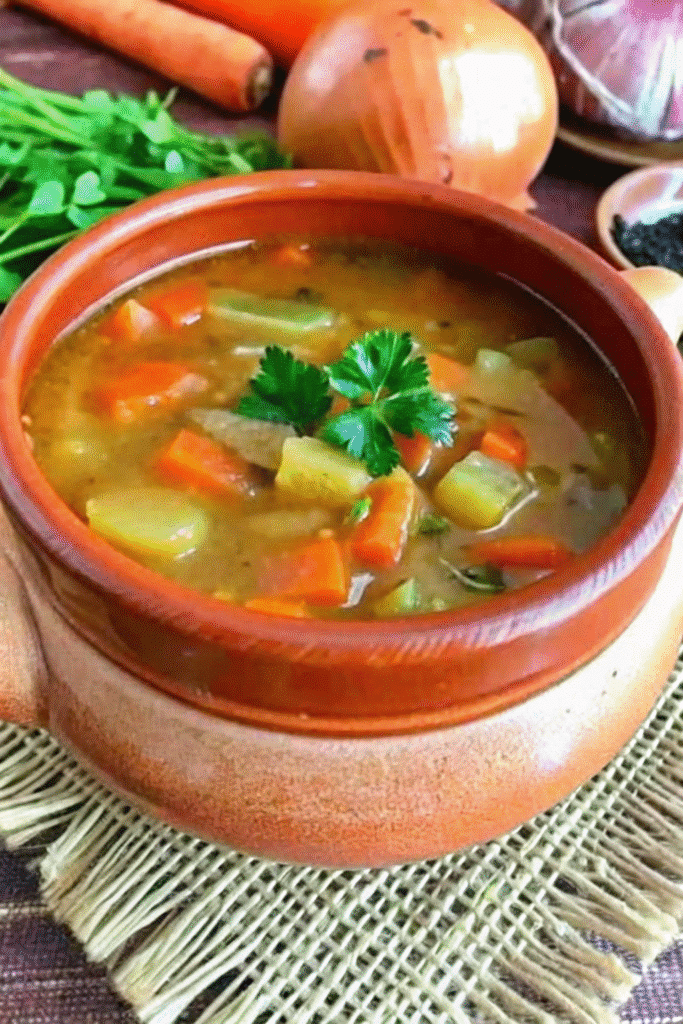 Freshly prepared Instant Pot Cabbage Soup with diced carrots, bell peppers, and cabbage, garnished and ready to serve.
