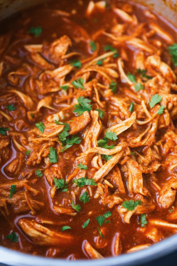 Juicy Mexican shredded chicken thighs fresh from the Instant Pot, ready for tacos or burritos