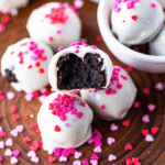 Close-up of Oreo Balls for Valentine Day coated in chocolate and decorated with heart sprinkles