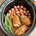 Slow Cooker Honey Garlic Chicken and Veggies with tender chicken thighs, baby potatoes, carrots, and green beans in a rich honey garlic sauce.