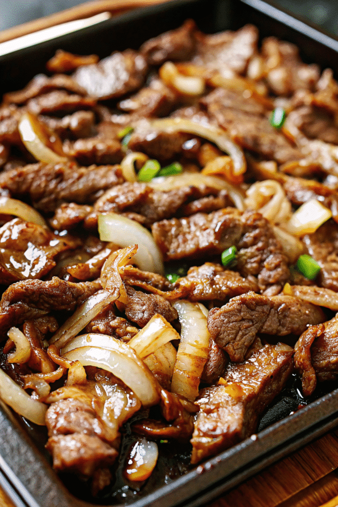Easy Sheet Pan Beef Bulgogi Recipe 3 A flavorful sheet pan beef bulgogi dinner with sweet and spicy marinated beef, roasted onions, and snap peas.