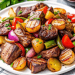Sheet pan balsamic glazed steak tips roasted with baby potatoes, asparagus, bell peppers, and red onion.