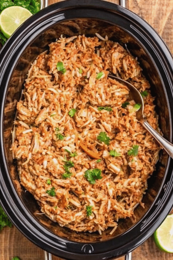 A warm bowl of Crock Pot Chili Con Carne with shredded beef, beans, and spices, perfect for cozy dinners.