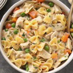 Crockpot Cheddar Chicken Pot Pie Tortellini in a slow cooker, with creamy sauce, tender chicken, vegetables, and melted cheddar cheese
