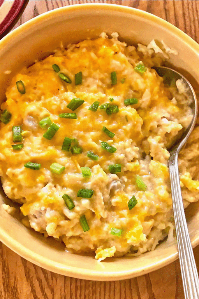 Creamy baked Slow Cooker Funeral Potatoes garnished with golden crushed potato chips