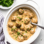 Slow Cooker Swedish Meatballs in creamy sauce served over mashed potatoes