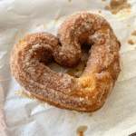 Heart-shaped Valentine Cinnamon Sugar Pretzels coated in cinnamon sugar with a soft strawberry-flavored dough.