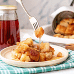 Crockpot French Toast Casserole with golden brown brioche cubes, topped with melted butter and cinnamon sugar, ready to serve.