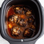 Southern Slow Cooker Oxtails served over mashed potatoes with rich brown gravy