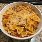 Creamy Velveeta Beef and Bowtie Pasta served in a bowl with melted cheese sauce and seasoned ground beef