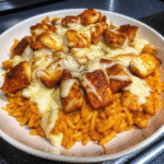 Queso Chicken and Rice Skillet with tender chicken, fluffy rice, and melted cheese topping