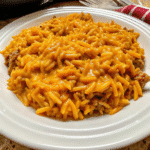 Cheesy Cheeseburger Orzo Skillet with melted cheddar, creamy sauce, and seasoned ground beef in a skillet