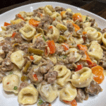 Cheesy Philly Steak Tortellini Skillet with shaved beef, bell peppers, onions, and cheese-filled tortellini in creamy melted cheese sauce.