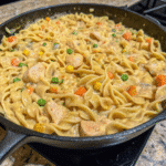 Creamy Chicken Pot Pie Pasta with tender chicken, mixed vegetables, and egg noodles in a rich sauce.